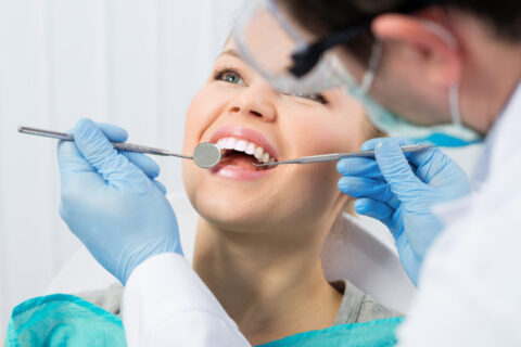 Regular dentist visit. Caries cure. Young woman visiting dentist
